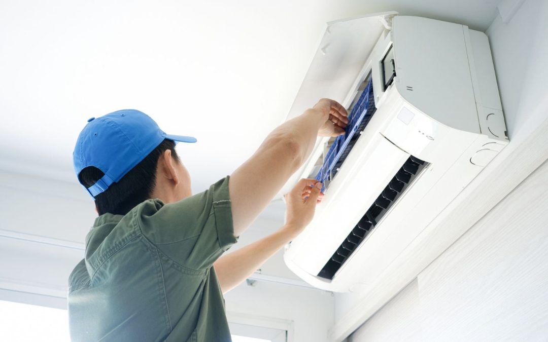 Air conditioning technician maintaining an indoor mini split system in Clearfield, UT